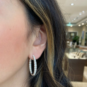 Female model wearing Graduated diamond interior and exterior hoops earrings
- 18K gold weighing 8.24 grams
- 42 round diamonds weighing 3.68 carats