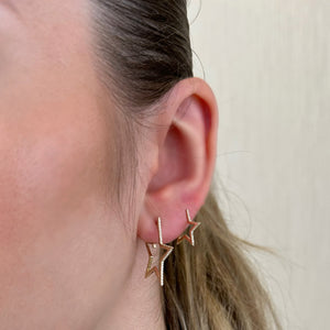 Female Model Wearing Diamond Star Hoop Earrings - 14K gold weighing 3.04 grams - 62 round diamonds weighing 0.20 carats