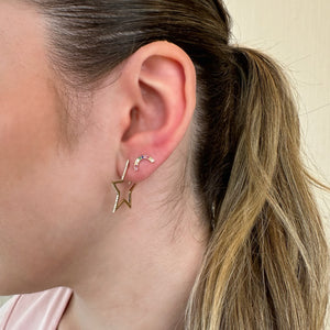 Female Model Wearing Diamond Star Hoop Earrings - 14K gold weighing 3.04 grams - 62 round diamonds weighing 0.20 carats