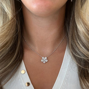 Female model wearing  Round & Pear-Shaped Diamond Flower Pendant Necklace - 18K gold weighing 6.32 grams - 5 pear-shaped diamonds weighing 1.49 carats - 30 round diamonds weighing 0.54 carats