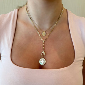 Female Model Wearing Diamond & Fluted Gold Four Leaf Clover “Love” Pendant Necklace - 14K gold weighing 3.90 grams - 30 round diamonds weighing 0.20 carats