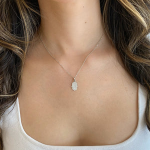 Female Model Wearing 0.39 ct Diamond Hamsa Pendant - 18K gold weighing 1.09 grams - 14K gold weighing 1.60 grams - 51 round diamonds weighing 0.39 carats