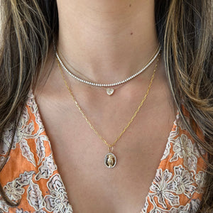 Female Model Wearing Diamond Mother Mary Pendant - 14K yellow gold weighing 1.75 grams - 42 round diamonds totaling 0.11 carats