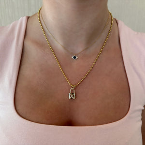 Female Model wearing Diamond Moon & Stars Padlock Pendant
- 14K gold weighing 4.77 grams
- 31 round diamonds weighing 0.25
carats