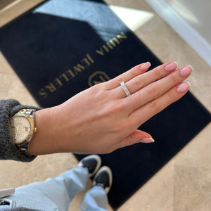 Female Model Wearing Radiant-Cut Diamond Wedding Band - 18K gold weighing 3.47 grams - 66 round diamonds weighing 0.24 carats - 8 radiant-cut diamonds weighing 2.35 carats